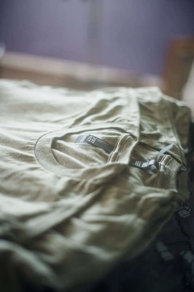 Stack of blank shirts waiting to be printed.