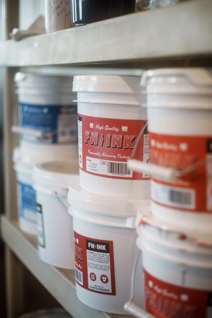 A Shelf of plastisol ink for screen printing.